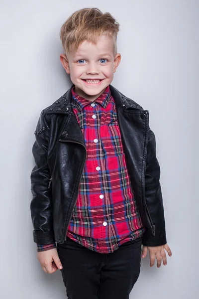 Fashionable child in leather jacket. Studio portrait over white background — Stock Photo, Image