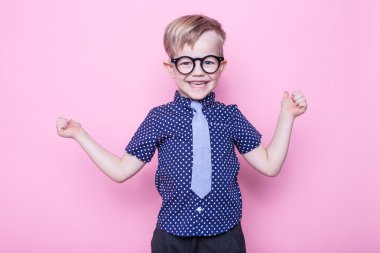 Portre küçük bir çocuk komik gözlük gülümseyen ve kravat. Okul. Okul öncesi. Moda. Stüdyo portre pembe bir arka plan üzerinde
