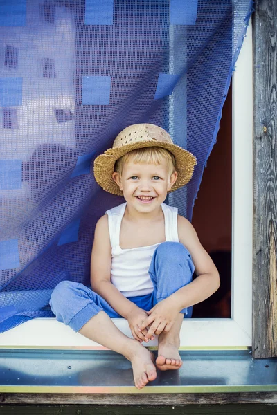 Young farmer sit on the window sill — Stock Photo, Image