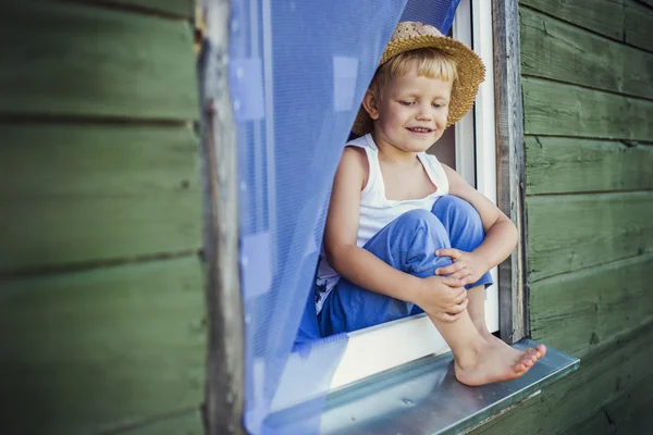 Young boy sit on the window sill — Stock Photo, Image