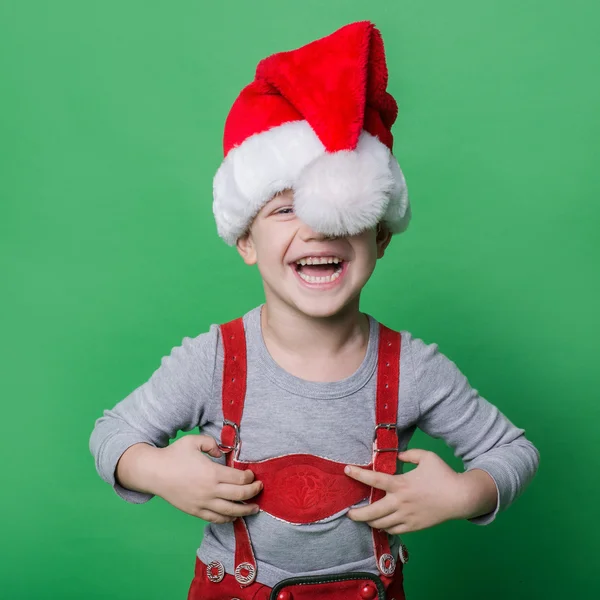 Rolig liten pojke med jultomten hatt skratt. Jul-konceptet — Stockfoto