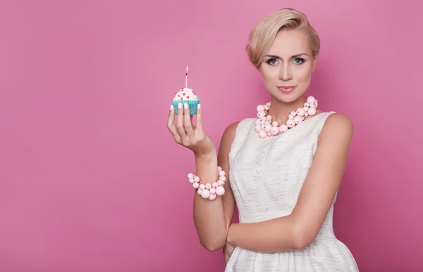 Happy Birthday. Beautiful young women holding small cake with colorful candle Stock Picture