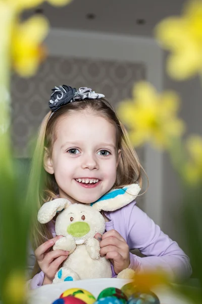 Smiling cute child with easter eggs and plush bunny. Easter — Stock Photo, Image