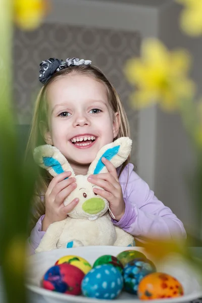 Happy little girl with toy bunny and easter eggs — Stock Photo, Image