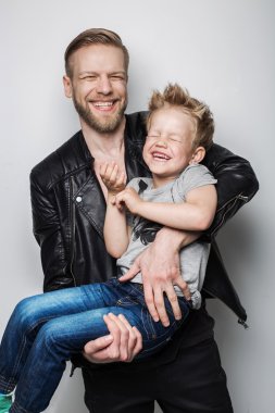 Young father and son laughing together. Fathers day