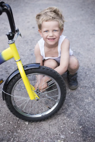 Boy Fixing Wheel Of Bike. Childhood.Cycling — Stock Photo, Image