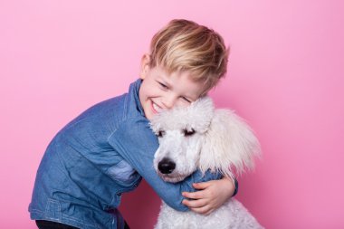 Royal standart kaniş güzel çocuk. Stüdyo portre pembe bir arka plan üzerinde. Kavram: çocuk ve köpek arasındaki dostluk