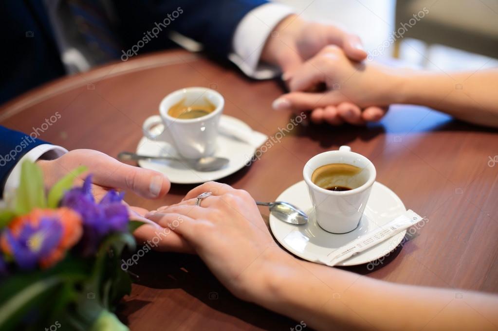 Lovers drinking coffee out of cups in the cafe. — Stock Photo
