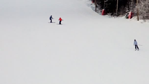 Skiërs toeristen beklimmen de piste de skiliften bij zonsondergang. — Stockvideo