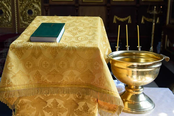 A font for the baptism of a child in a church. The ceremony of the Christian religion.