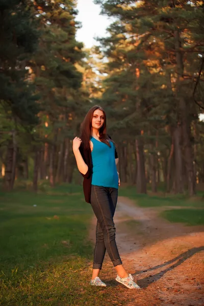 Lovely girl hippie walks in the park at sunset. Warm toning — Stock Photo, Image