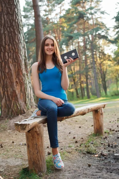 Girl with a VHS cassette in her hands — Stock Photo, Image