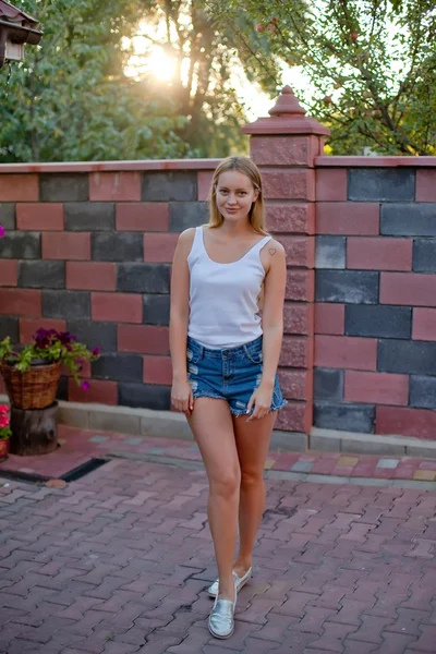 Smiling young blondie teenage posing in yard of her residence — Stock Photo, Image