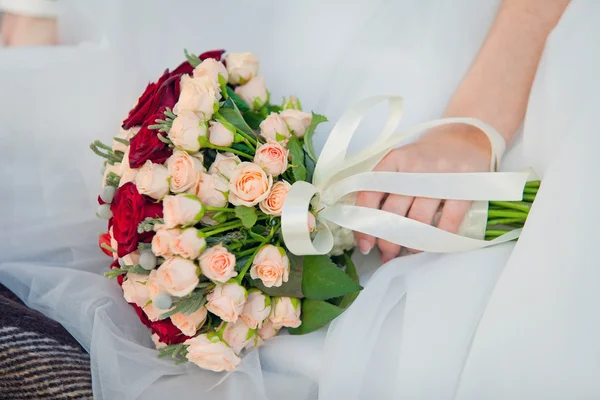 Wedding bouquet on wedding dress — Stock Photo, Image