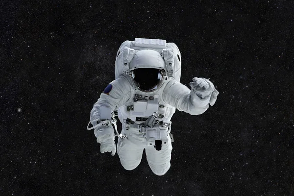 Spaceman viaja em um fundo de estrelas. Astronauta no espaço exterior — Fotografia de Stock