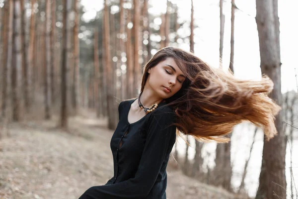 Atrakcyjna młoda kobieta korzystających z jej czasu na zewnątrz w parku. Długie włosy latające z boku — Zdjęcie stockowe
