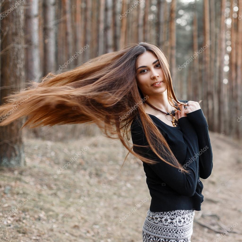 Beautiful girl with long hair walking in the park Long Beautiful girl with long hair walking in the park Long