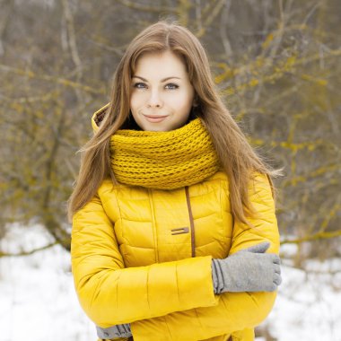 Pretty woman in a yellow knit scarf. 