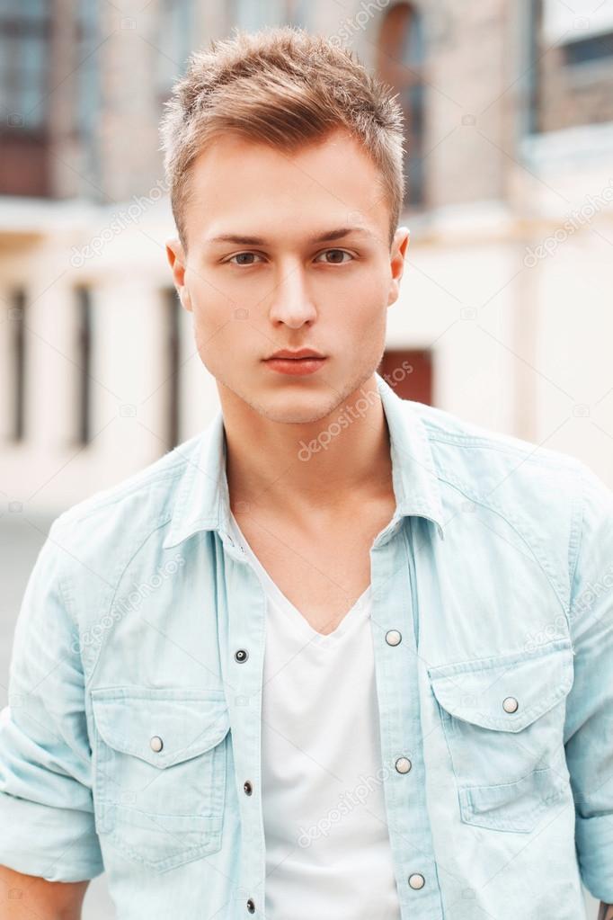 close-up portrait of a young man in jeans clothes