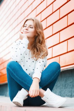 Beautiful stylish girl dreams of the good.