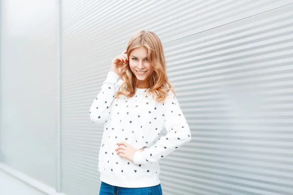 Portrait of fashionable fun girl with a beautiful smile on a light background. — Zdjęcie stockowe