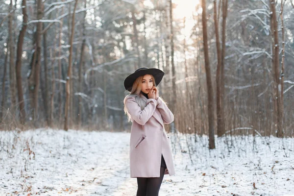 Young beautiful girl in fashionable clothes on a sunny winter da