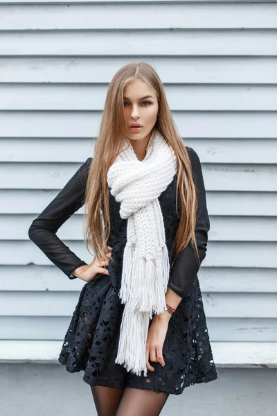 Young stylish girl in a white knitted scarf and a black dress — 스톡 사진