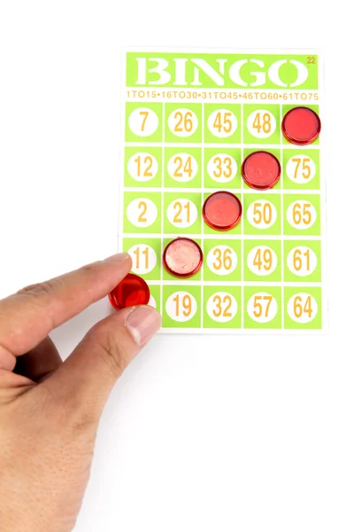 Mão colocando último chip para ser vencedor do jogo de bingo — Fotografia de Stock