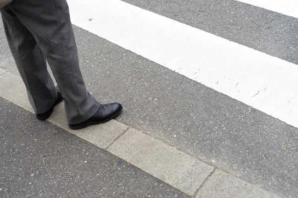 Man legs in slag pants waiting to cross the street at a crosswal — Stock Photo, Image