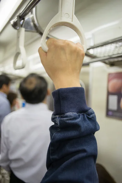 Hand of passengers hold on rail handle of transit system — Stock Photo, Image