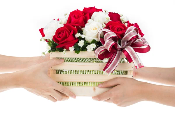 Hand delivers baskets of red and white rose flowers — Stock Photo, Image