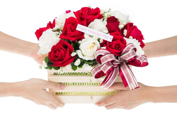 Hand delivers baskets of red and white rose flowers — Stock Photo, Image