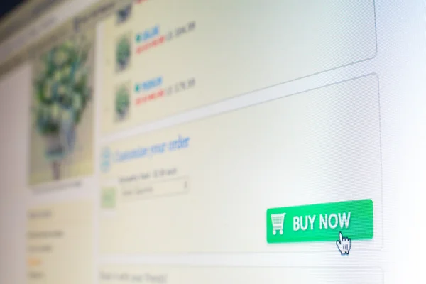 Mouse clicking "buy now" button on website Stock Image