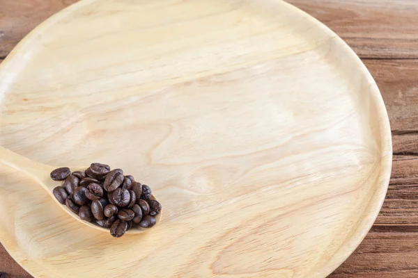 Kaffeebohne auf Holzlöffel, Schüssel, Tischhintergrund — Stockfoto