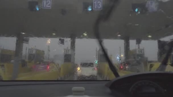 Rain splatters car windshield during storm while passing the toll to highway — Stock Footage Rain splatters car windshield during storm while passing the toll to highway Video Clip