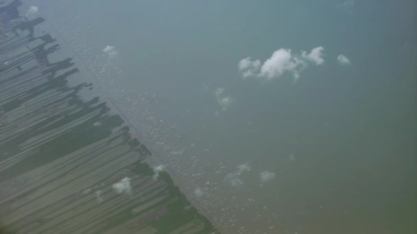 Vista desde arriba, sobre las nubes, escena rural y costera abajo — Vídeo de stock
