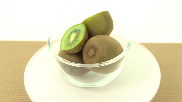 Fresh, ripe, green kiwis in rotating bowl — Stock Video