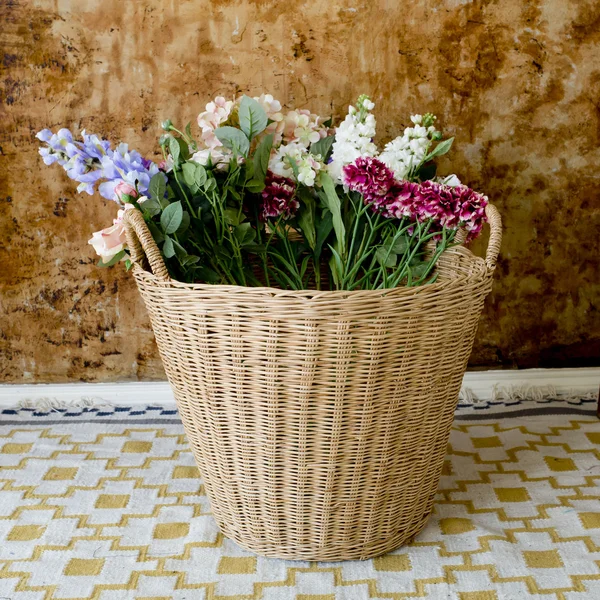 Colorful flowers in a basket — Stock Photo, Image