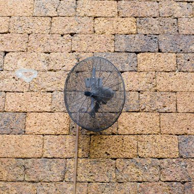 Vintage tuğla duvar siyah metal fan ile.