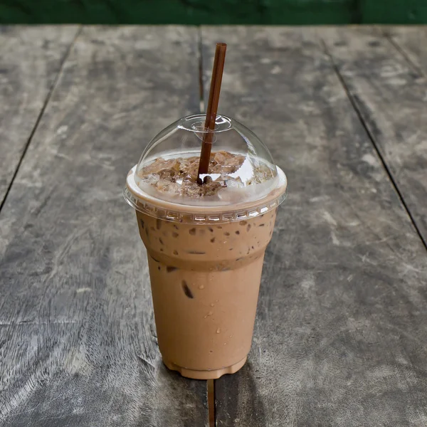 Cold coffee drink with ice on old wood table — Stock Photo, Image