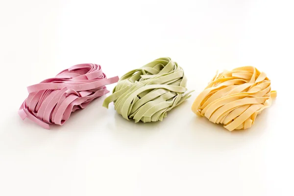 Bundles of dried ribbon color  pasta — Stock Photo, Image