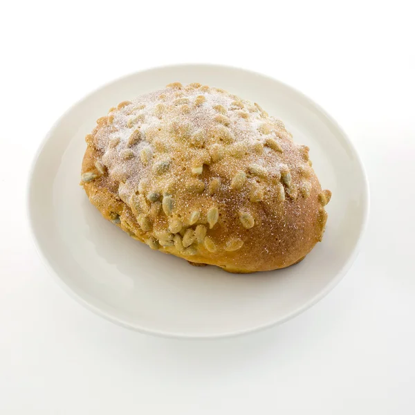 Fresh bread with soybean and icezing topping on white plate isol — Stock Photo, Image