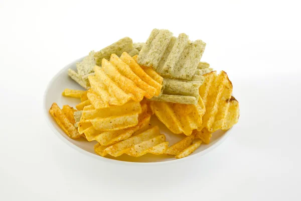 Mixed potato crisps and corn flake cereal on white background — Stock Photo, Image