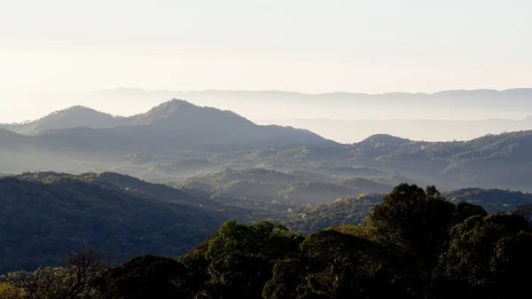 Layers of mountains and fog at sunrise — Stock Photo, Image