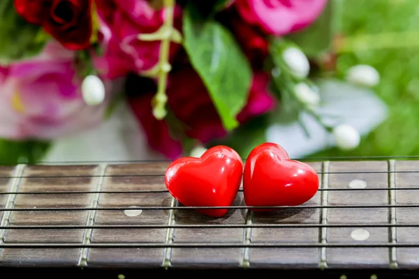 Heart on neck guitars and strings on the grass — Stock Photo, Image