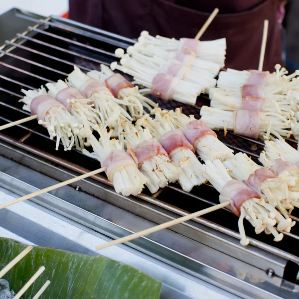 Roast bacon wrapped Flammulina Velutipes with skewer, street foo — Stock Photo, Image