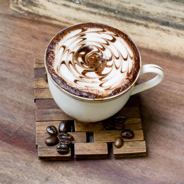 Cup of coffee on a wooden table — Stock Photo, Image