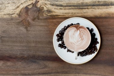 Tahta bir masada bir fincan kahve.