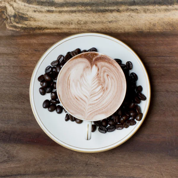 Cup of coffee on a wooden table — Stock Photo, Image