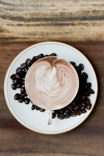 Cup of coffee on a wooden table — Stock Photo, Image